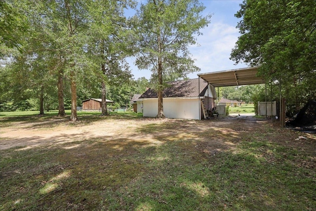 100 Teakwood St, Silsbee, TX 77656 - view of yard with a carport and an outbuilding