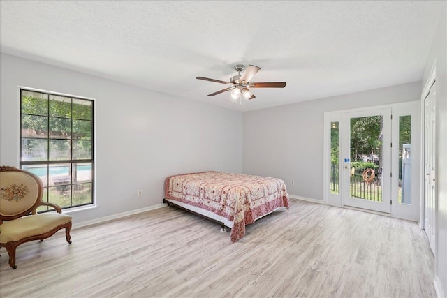 100 Teakwood St, Silsbee, TX 77656 - bedroom featuring access to exterior, light wood finished floors, ceiling fan, and a textured ceiling