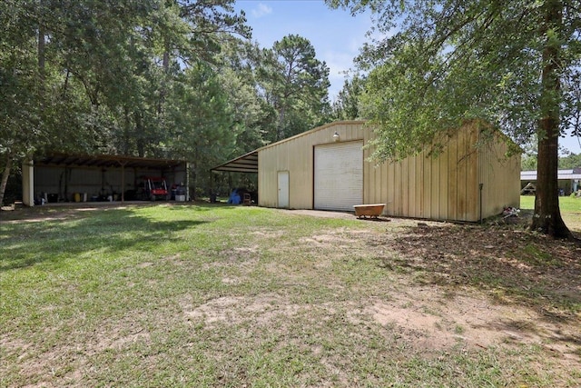 100 Teakwood St, Silsbee, TX 77656 - view of grassy yard with an outbuilding, a garage, and driveway