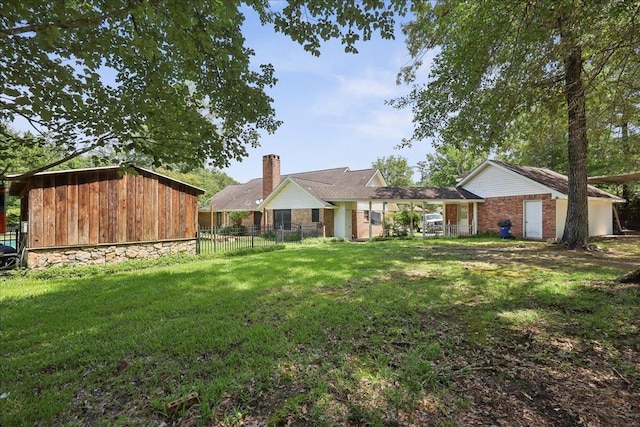 100 Teakwood St, Silsbee, TX 77656 - back of property with brick siding and a chimney