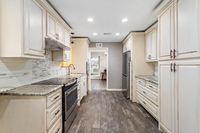 kitchen featuring appliances with stainless steel finishes, visible vents, under cabinet range hood, and dark wood-style floors