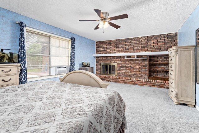 carpeted bedroom featuring a textured ceiling, ceiling fan, cooling unit, brick wall, and a brick fireplace