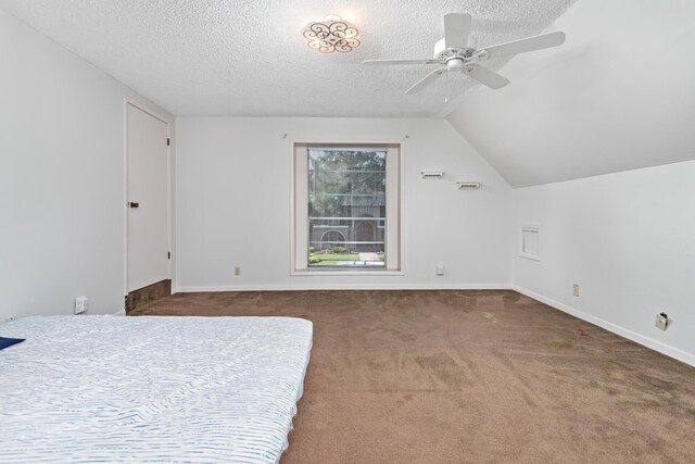 bedroom featuring a textured ceiling, lofted ceiling, carpet flooring, a ceiling fan, and baseboards