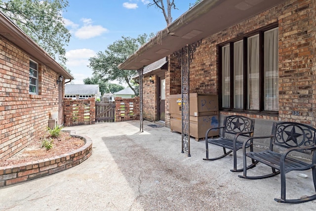 view of patio / terrace featuring a gate and fence