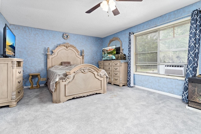 carpeted bedroom with wallpapered walls, baseboards, ceiling fan, a textured ceiling, and cooling unit