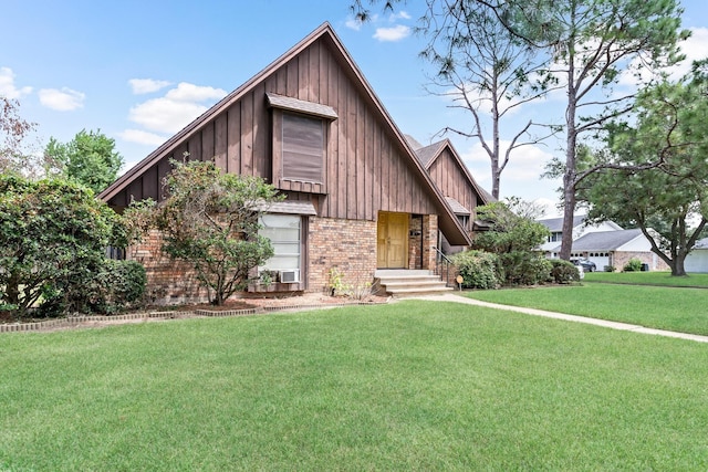 view of front of home with brick siding, board and batten siding, and a front yard