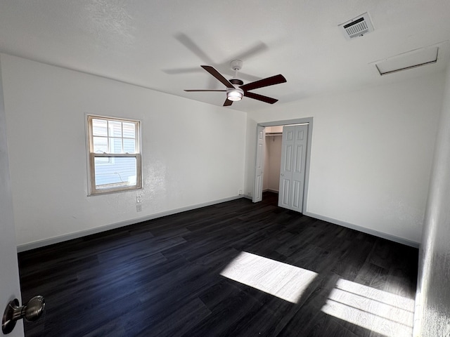 unfurnished bedroom with dark hardwood / wood-style floors, ceiling fan, and a closet