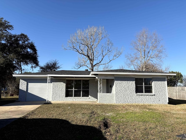 ranch-style home featuring a garage and a front yard