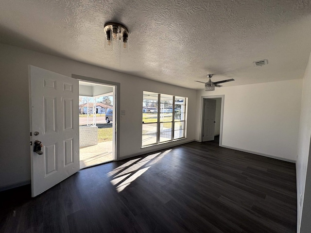 interior space with a textured ceiling, dark hardwood / wood-style floors, and ceiling fan