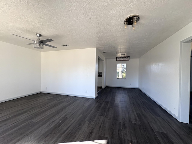 unfurnished living room featuring dark wood-type flooring, a textured ceiling, and ceiling fan