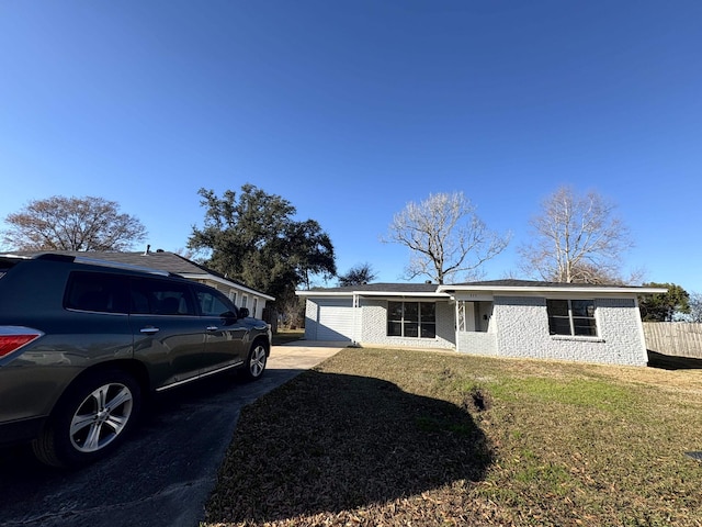 ranch-style house with a front lawn