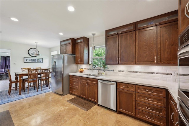 5775 Clinton St, Beaumont, TX 77706 - kitchen with stainless steel appliances, tasteful backsplash, decorative light fixtures, recessed lighting, and light stone counters