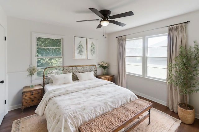 bedroom featuring multiple windows, ceiling fan, and dark hardwood / wood-style floors