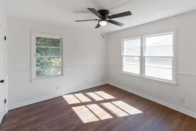 unfurnished room featuring ceiling fan and dark hardwood / wood-style flooring