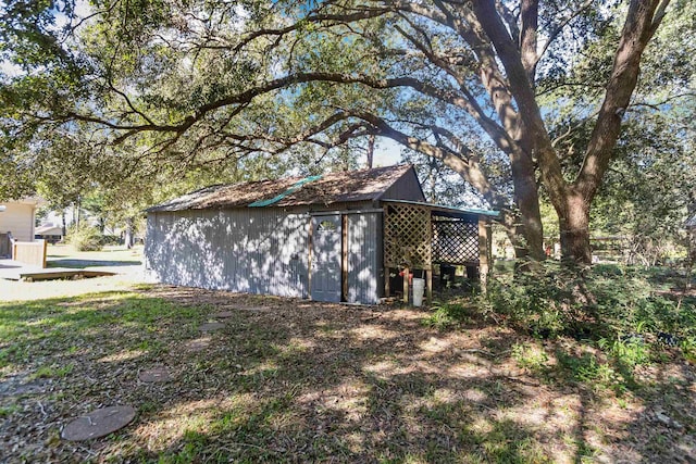 view of property exterior featuring an outdoor structure