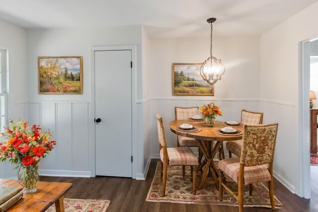 dining space featuring dark hardwood / wood-style floors and a notable chandelier