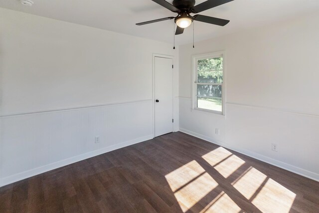 spare room with ceiling fan and dark wood-type flooring