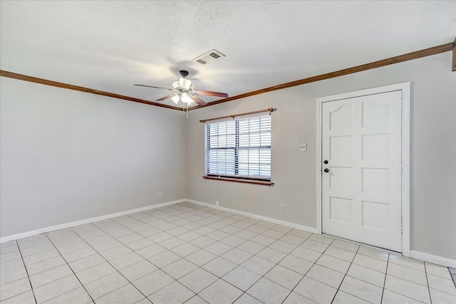 empty room with visible vents, a ceiling fan, crown molding, and a textured ceiling