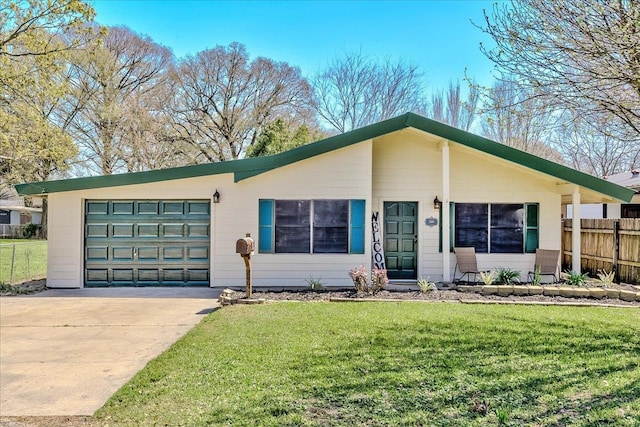 view of front of property with an attached garage, concrete driveway, a front yard, and fence