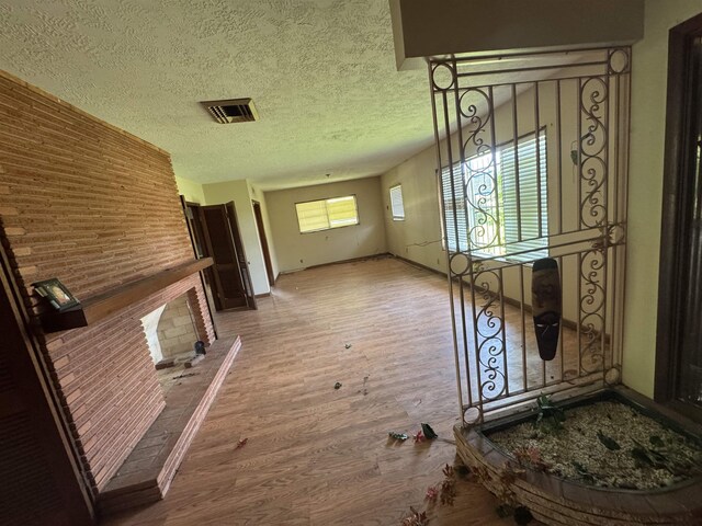 2595 Beech St, Beaumont, TX 77702 - hall with wood finished floors and a textured ceiling