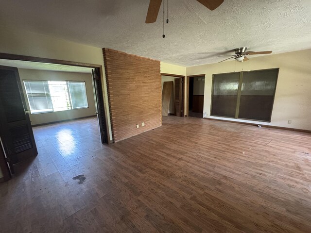 2595 Beech St, Beaumont, TX 77702 - spare room featuring ceiling fan, dark wood finished floors, and a textured ceiling