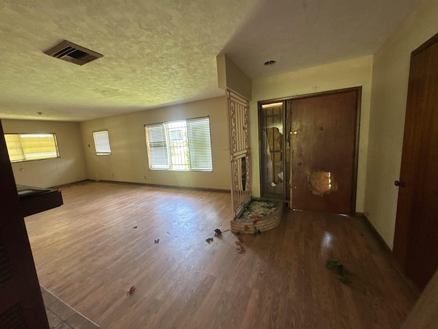 2595 Beech St, Beaumont, TX 77702 - entrance foyer featuring wood finished floors, plenty of natural light, and a textured ceiling