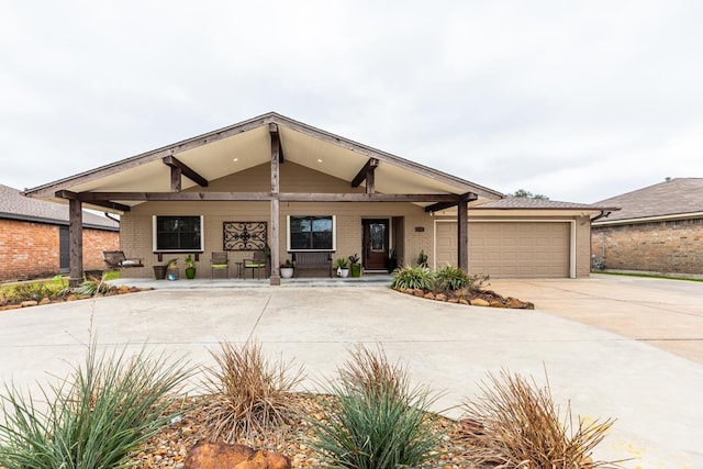 view of front of house with an attached garage, concrete driveway, and brick siding