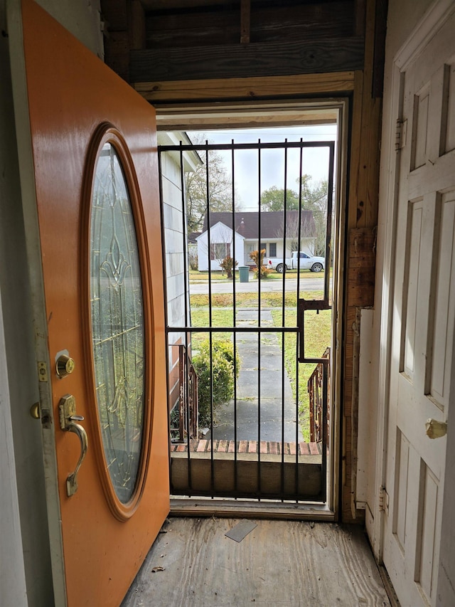 doorway featuring a residential view and wood finished floors