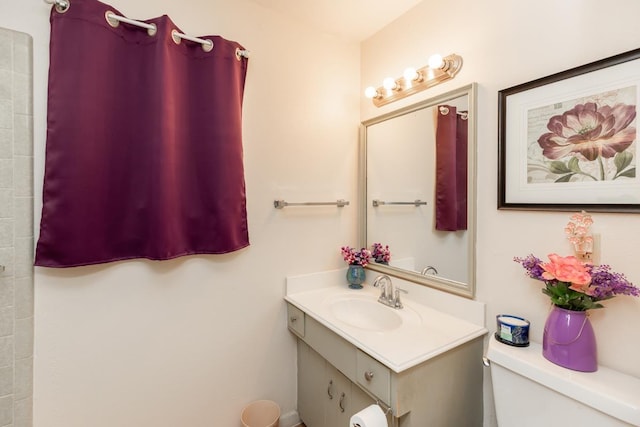 bathroom featuring toilet and vanity