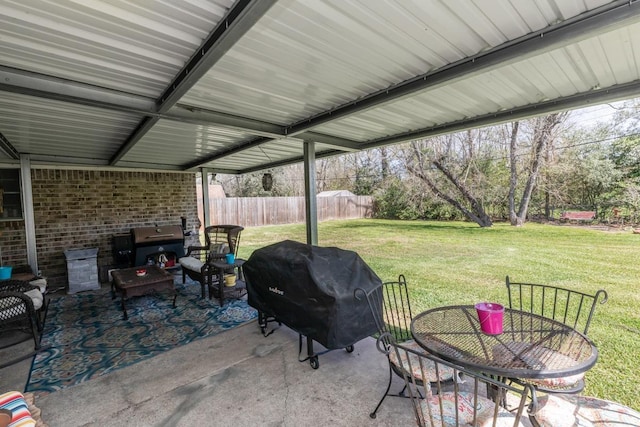 view of patio featuring a grill and fence