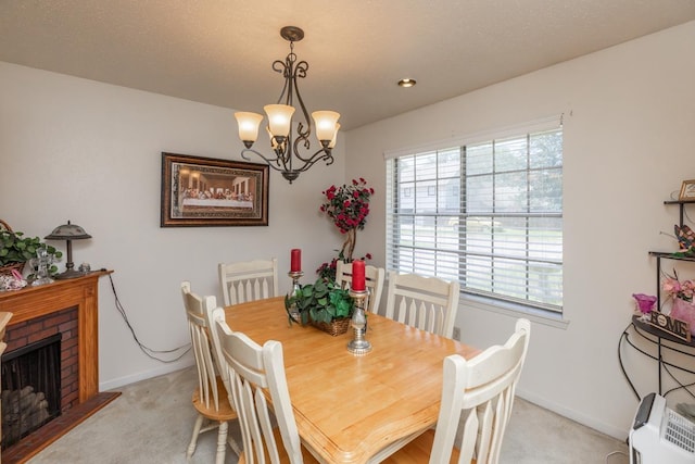 dining area featuring an inviting chandelier, plenty of natural light, light colored carpet, and baseboards