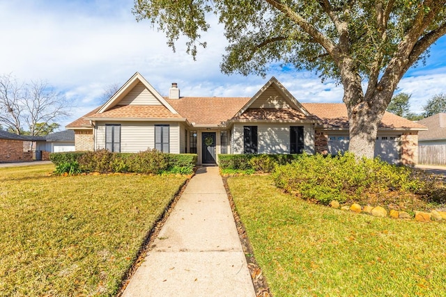 view of front of property with a front lawn and a garage