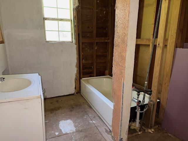1700 Woodrow St, Silsbee, TX 77656 - bathroom with a tub to relax in and vanity