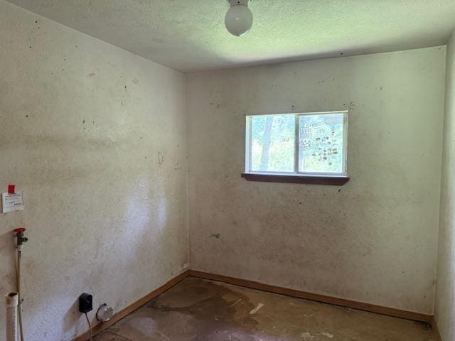 1700 Woodrow St, Silsbee, TX 77656 - unfurnished room with baseboards and a textured ceiling