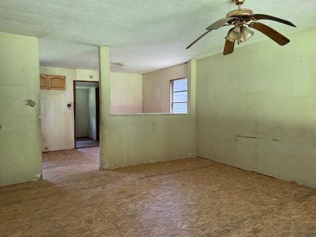 1700 Woodrow St, Silsbee, TX 77656 - empty room featuring a textured ceiling and a ceiling fan