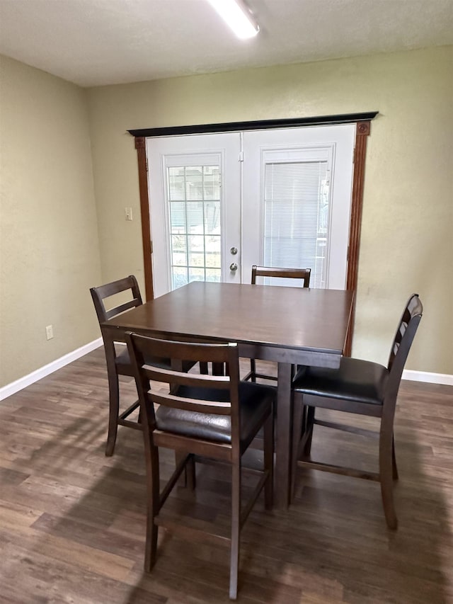 dining space featuring french doors, baseboards, and dark wood-style floors