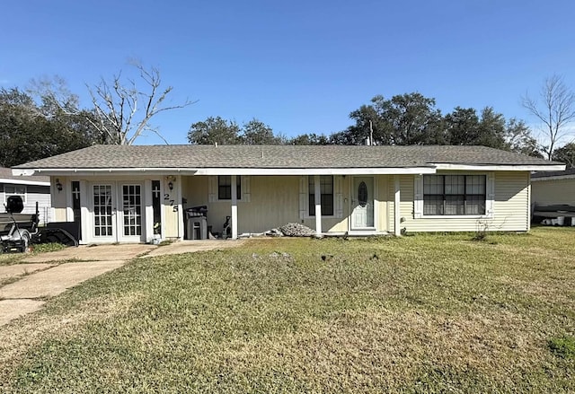 ranch-style house featuring french doors and a front lawn