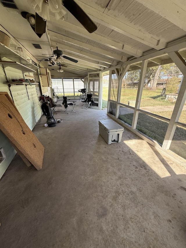 unfurnished sunroom featuring lofted ceiling with beams, a ceiling fan, and visible vents