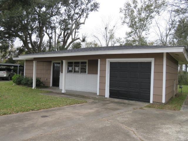 exterior space featuring a front lawn and a garage