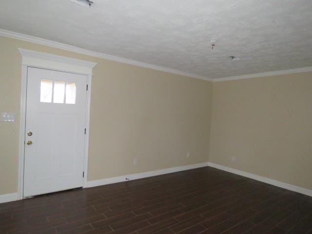 entrance foyer with dark wood-type flooring and ornamental molding