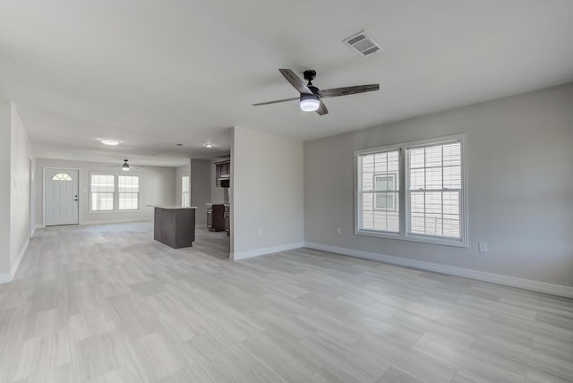 unfurnished living room featuring ceiling fan