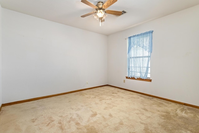 empty room with carpet floors, baseboards, and a ceiling fan