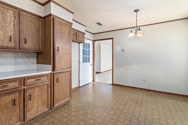 kitchen featuring ornamental molding, brown cabinetry, light countertops, pendant lighting, and tile patterned floors