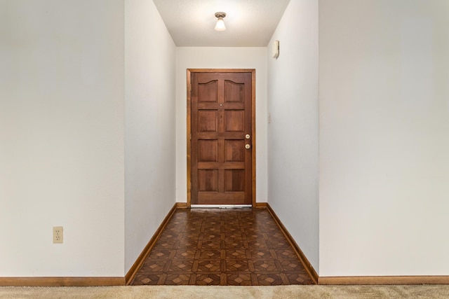 doorway to outside with baseboards