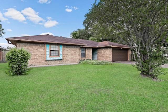 ranch-style home with brick siding, an attached garage, and a front lawn