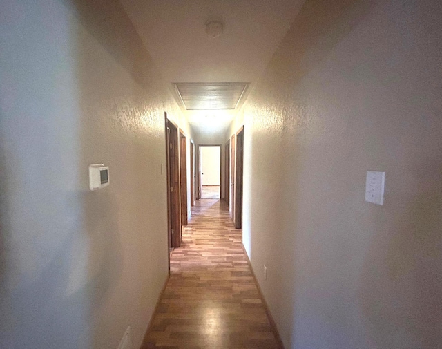 205 Turner Ln, Bridge City, TX 77611 - hallway featuring light wood finished floors and a textured wall