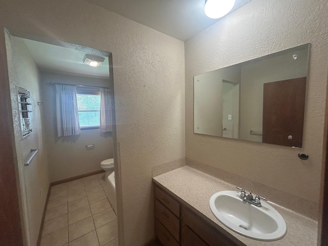 205 Turner Ln, Bridge City, TX 77611 - bathroom with a textured wall, vanity, and tile patterned flooring