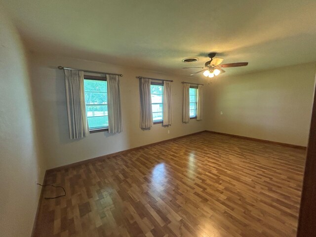 205 Turner Ln, Bridge City, TX 77611 - empty room with wood finished floors and a ceiling fan