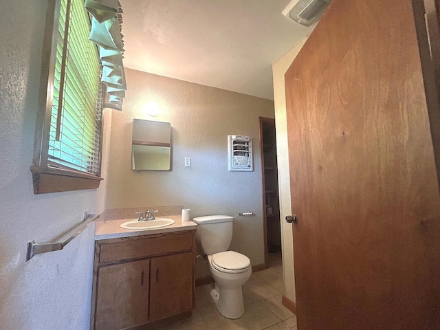 205 Turner Ln, Bridge City, TX 77611 - half bath featuring a textured wall, vanity, and tile patterned flooring