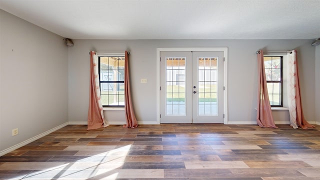 doorway with french doors and dark wood-type flooring